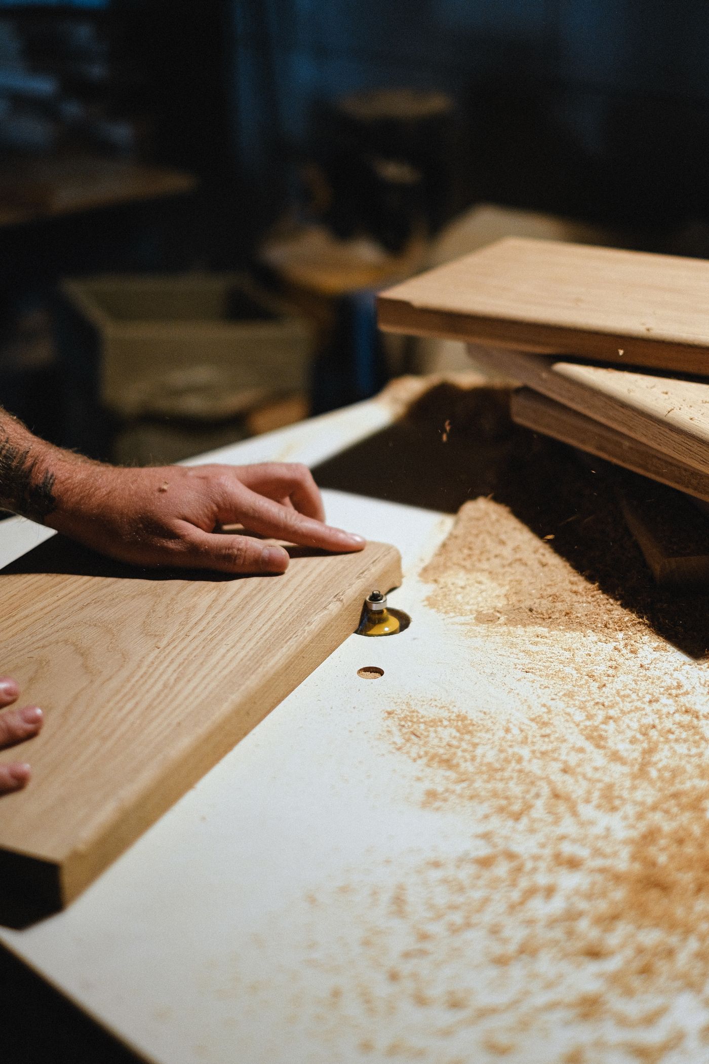Carpenter measuring a wood board in a workshop