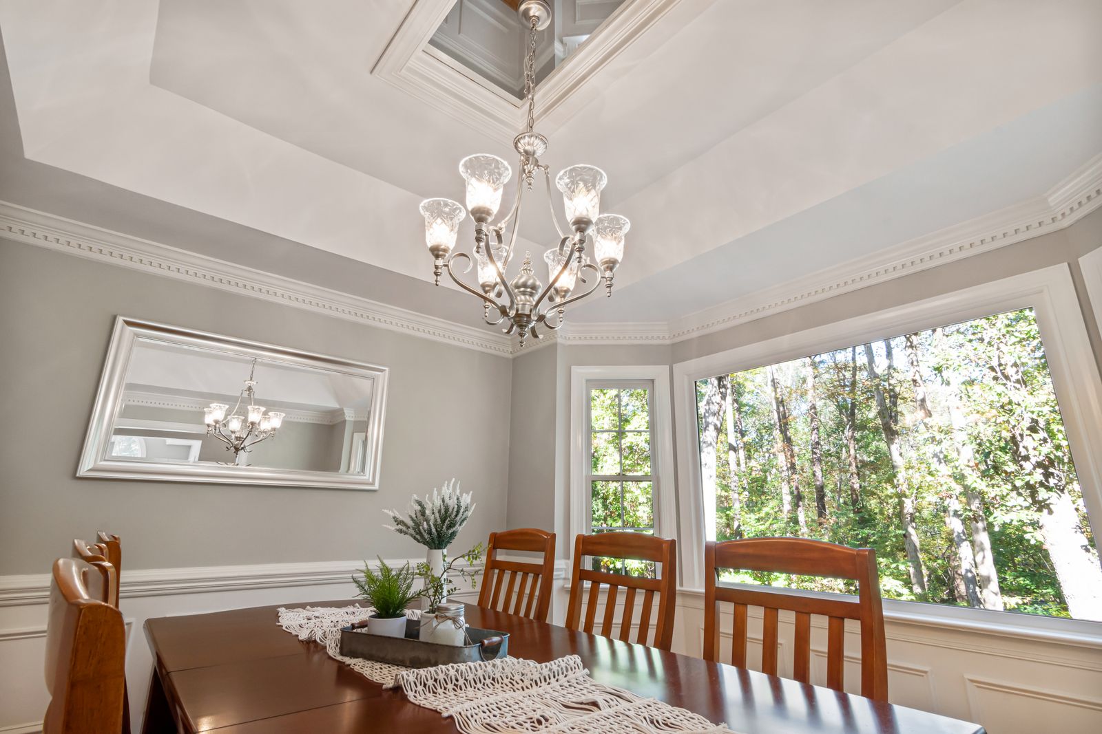 Room with crown molding and wainscoting
